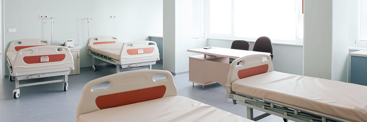 Bright, open hospital room with 4 beds.